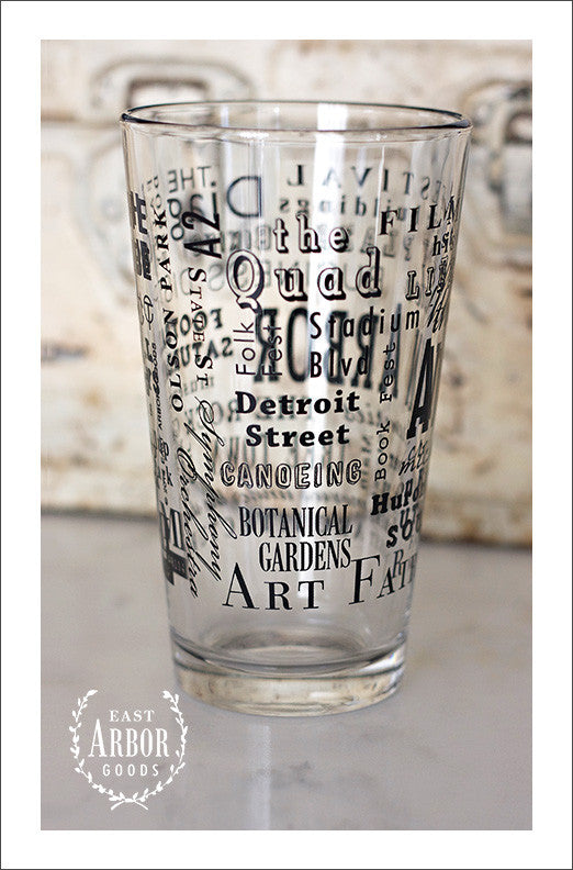 Left side view of Pint Glass featuring Ann Arbor, Michigan with highlights from the town in black screen print