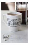 Back of white ceramic coffee mug featuring Ann Arbor, Michigan with places and activities featured in different fonts in black screen print.  